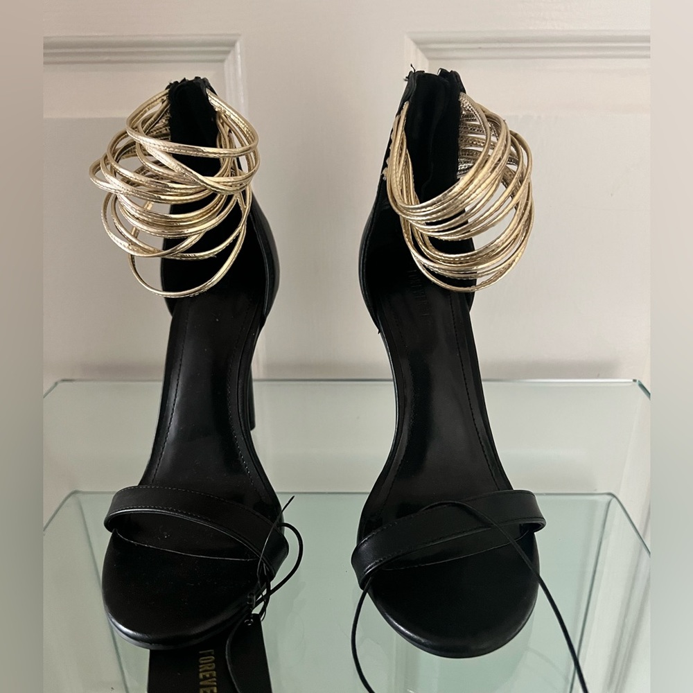 Beautiful Brand NEW stiletto heels with gold straps design around ankle.